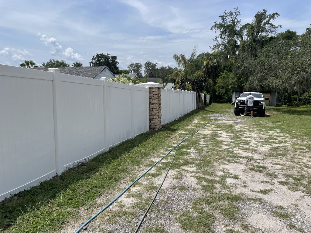 white fence cleaning in progress